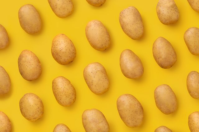 Potato on a colored background. Pattern of potato. Natural potato