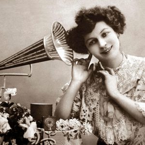 Woman listening to music with gramophone