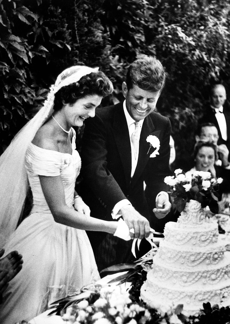 John F. Kennedy and Jacqueline Bouvier cut the cake