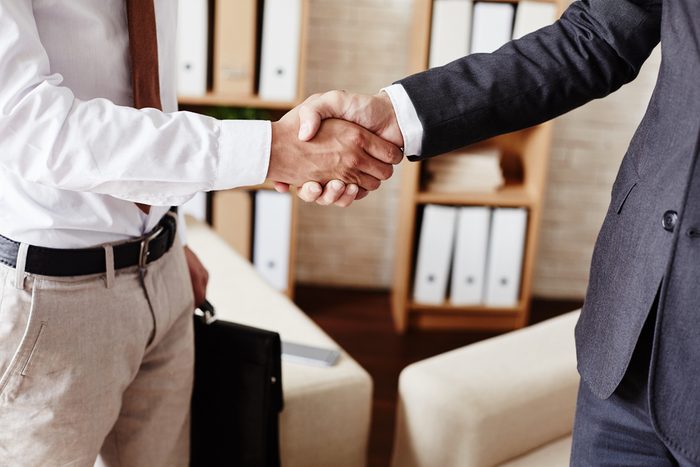 Businessmen handshaking after signing contract