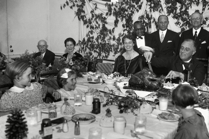 Mandatory Credit: Photo by AP/Shutterstock (6003359a) President Franklin D. Roosevelt carves the turkey during the annual Thanksgiving dinner for polio patients at Warm Springs, Ga., with first lady Eleanor Roosevelt smiling beside him FDR Carves Turkey 1933, Warm Springs, USA
