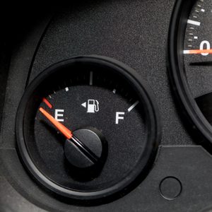 Low fuel guage shown in a car shot close up