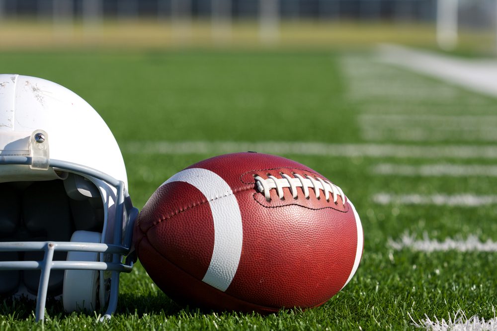 American Football and Helmet on the Field with room for copy