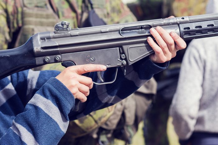 ak 4 rifle in boy's hands