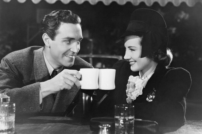 Couple toasting with mugs