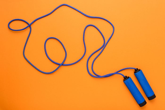 top view of sports jumping rope isolated on orange, sport background concept