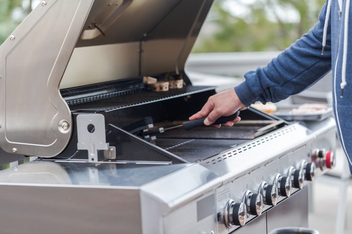 Cleaning outdoor gas grill before next grilling.