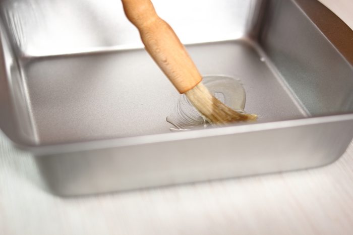 Brushing baking pan with butter. Making Potato and Leek Filo Pie. Series.