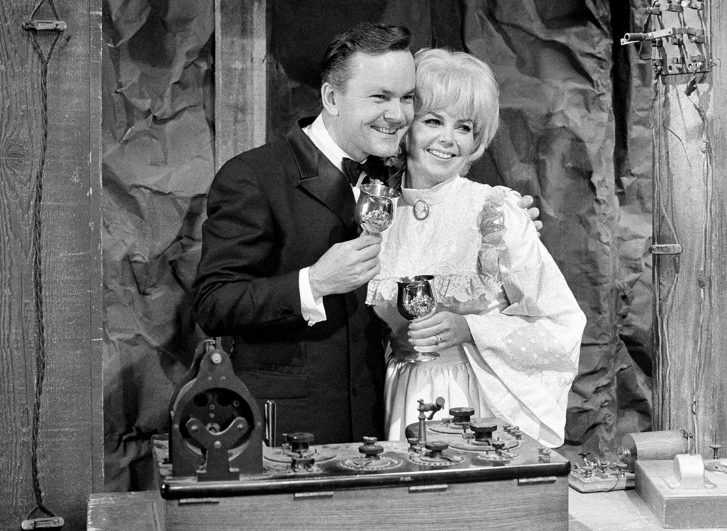 Actor Bob Crane, star of the television series "Hogan's Heroes", poses with fellow cast member Sigrid Valdis after they were married on the studio set in Hollywood, . Valdis, who played Colonel Klink's secretary on "Hogan's Heroes", died Oct. 14, 2007. Scotty Crane told the Los Angeles Times that his mother died of lung cancer. She was 72 Obit Klinks Secretary, Hollywood, USA