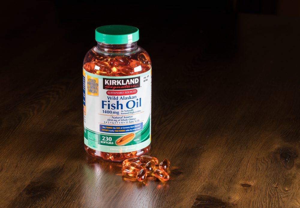 Kirkland Wild Alaskan Fish Oil capsules and bottle on wooden table