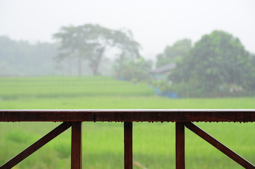 Wooden rail of house terrace in raining