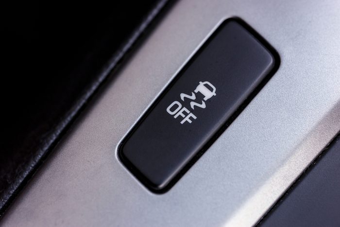 Slippery button. An image of a button for traction control in a modern car