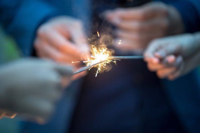 Blurry of hands with firework.Picture showing group of friends having fun with sparklers
