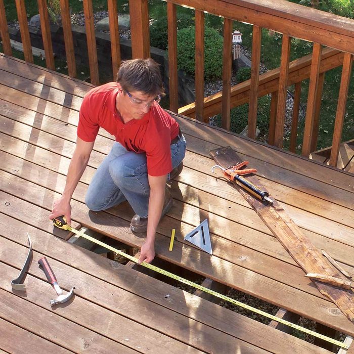 man repairing his deck