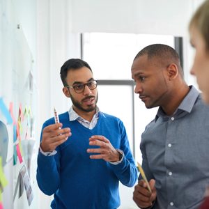 Multi-ethnic group hipster trendy business people discussing during a brainstorm session for their small company