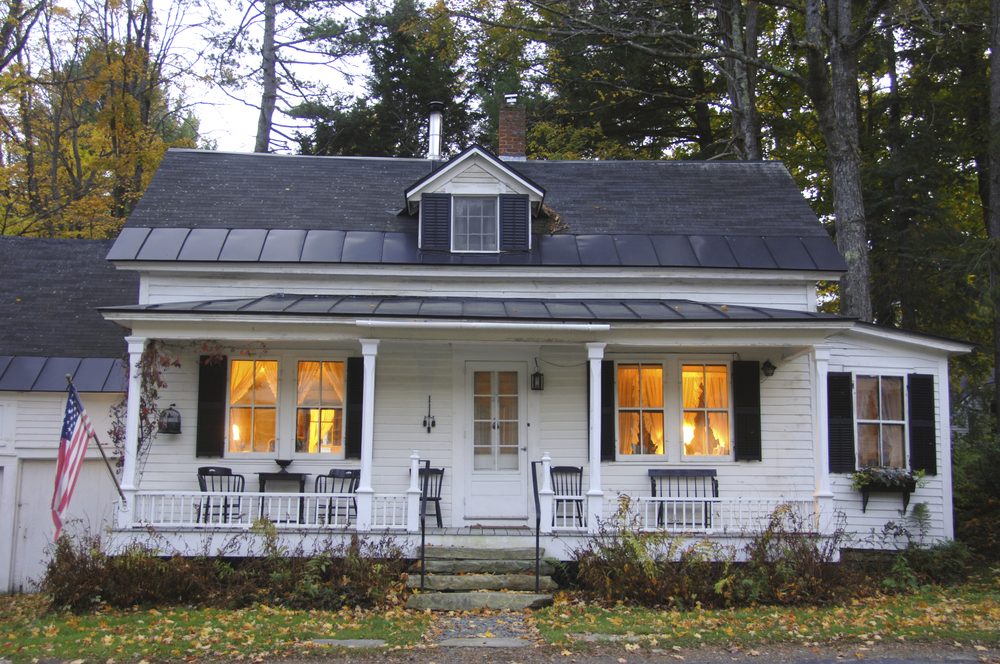 White clapboard house with a white picket fence