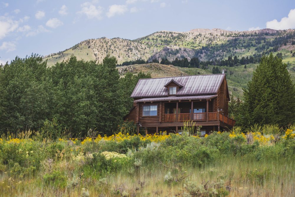 Quaint house on hillside  in green mountain landscape of central Montana.