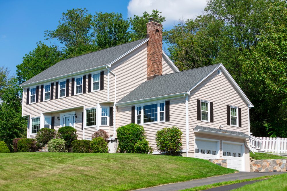 American traditional Colonial house front view in summer