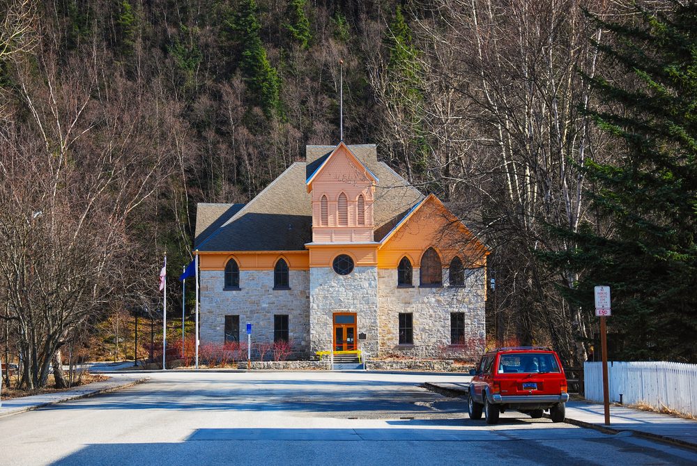 House and vehicle around with tree in  Skagway Alaska, Tower,Hoose style 