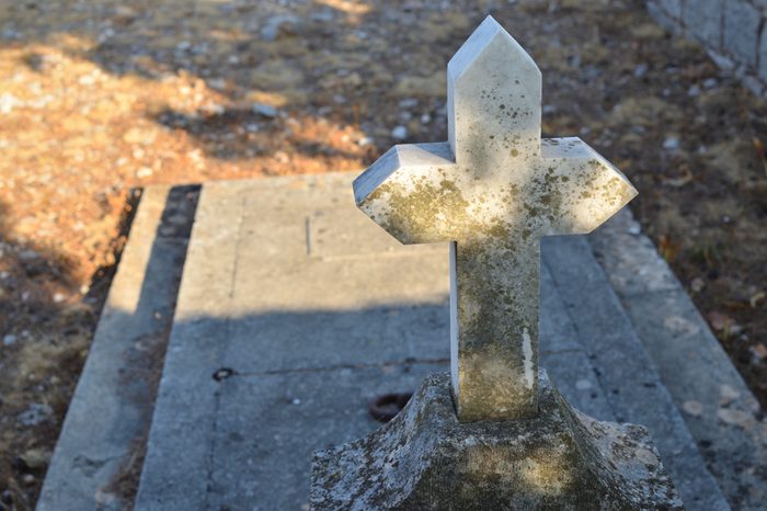 Old stone cross of a grave with a grave ledger