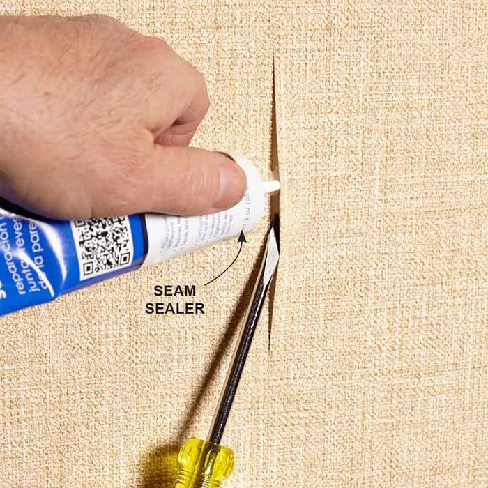 man fixing wallpaper