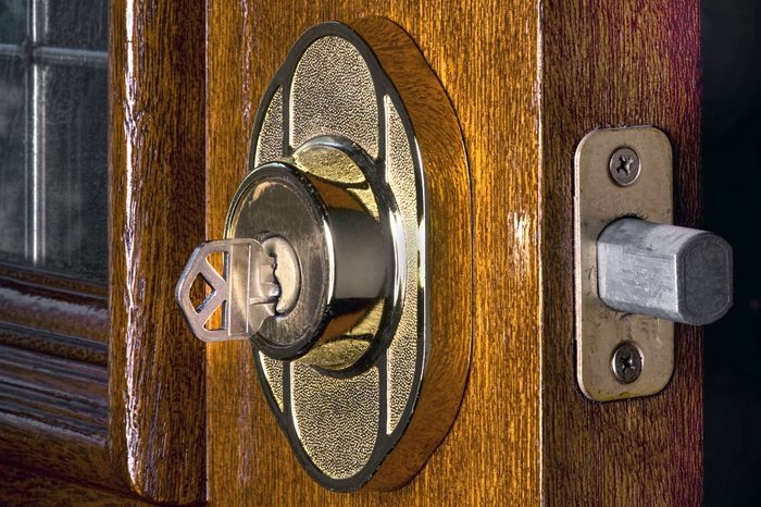 Deadbolt lock on mahogany front door.