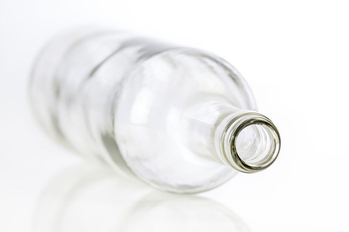 Empty glass bottle isolated on white background