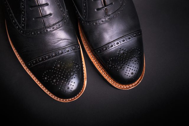 black oxford shoes with shoelace top view closeup