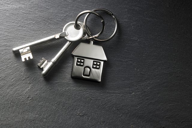 house shaped key chain on the black slate