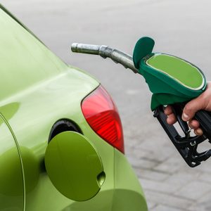 Man fills up his car with a gasoline at gas station