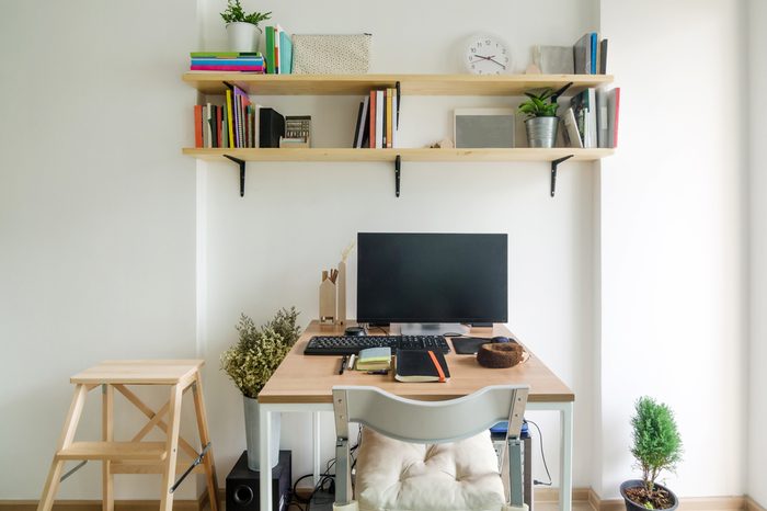 Home office working space. wooden shelf with white wall