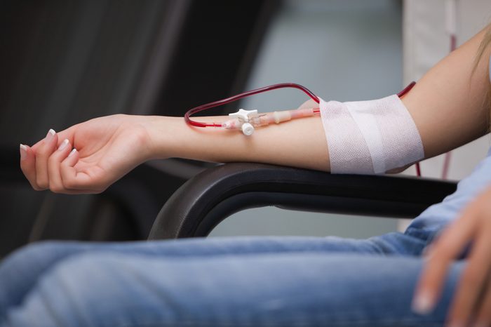 Woman getting a transfusion while sitting on a chair