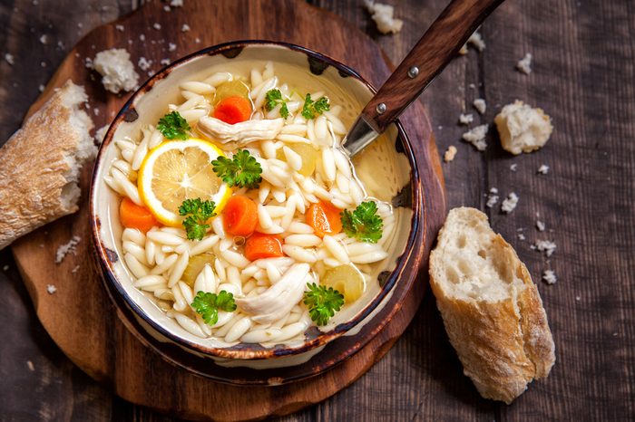 Bowl of Italian Lemon Chicken Orzo Soup. Rustic Style