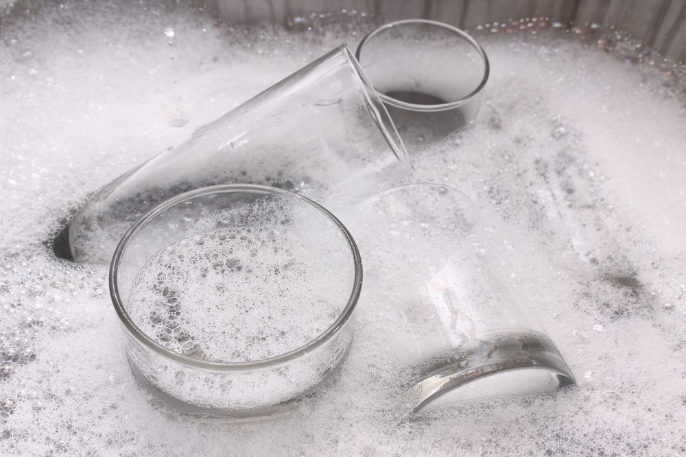 Washing dirty glasses with detergent and water