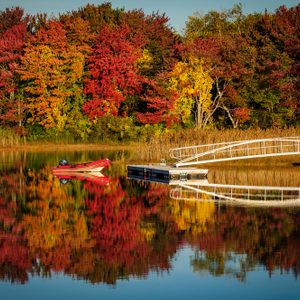 Dinghy on lake with fall foliage near Kennebunkport, Maine in autumn