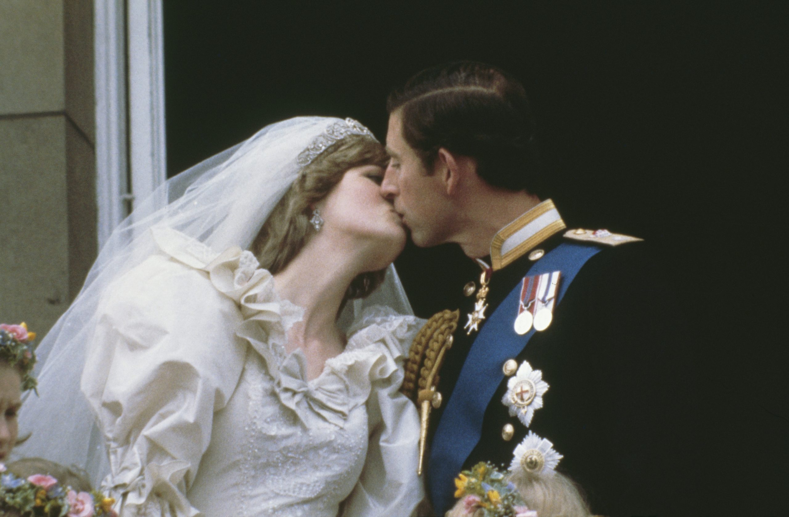 Prince Charles, Prince of Wales, kissing his wife, Princess Diana (1961 - 1997), on the balcony of Buckingham Palace in London after their wedding