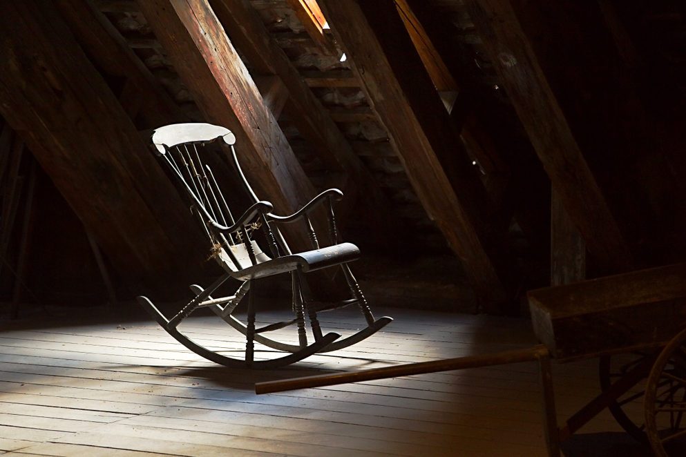 Old rocking chair on a dim attic