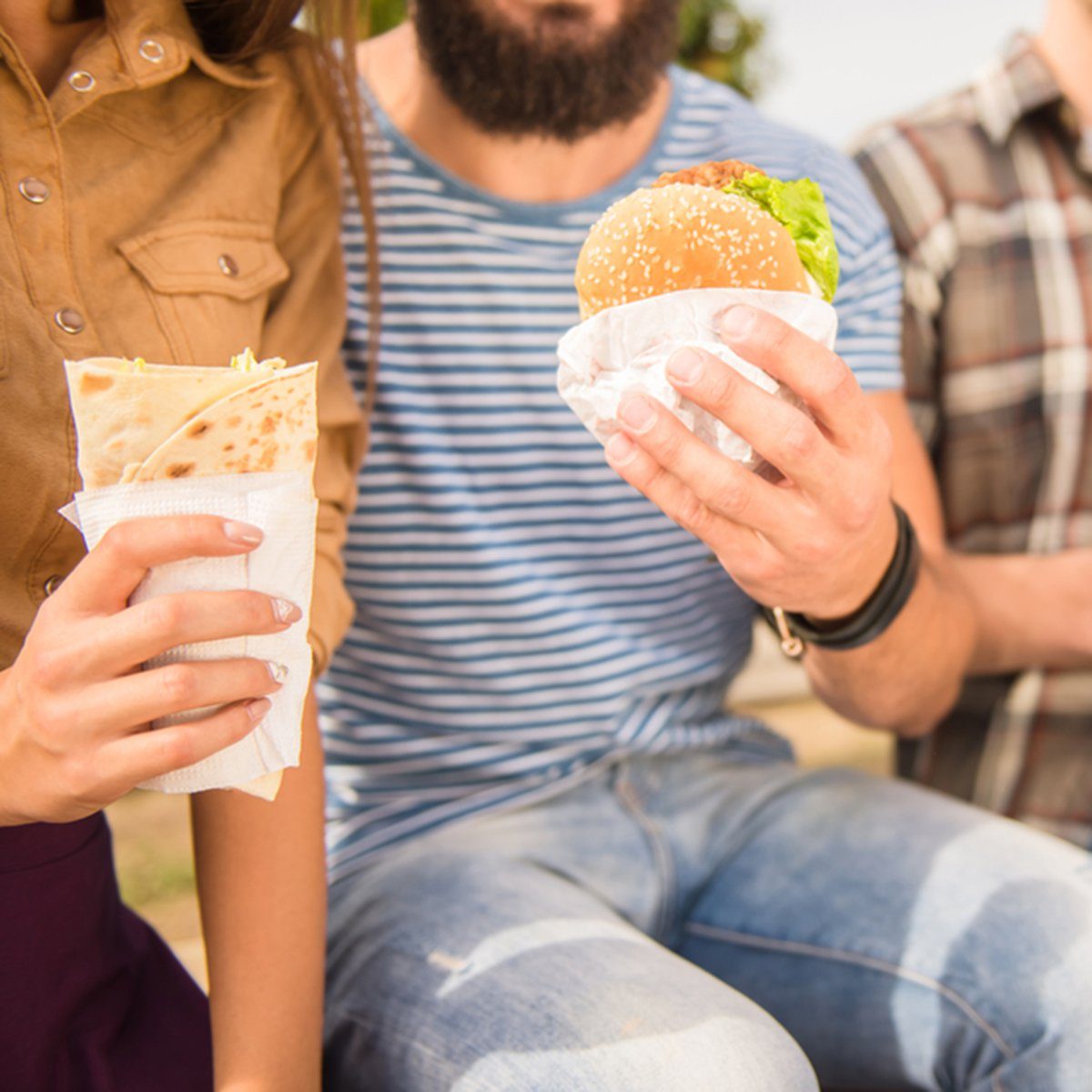 Sitting in the park and eat fast food