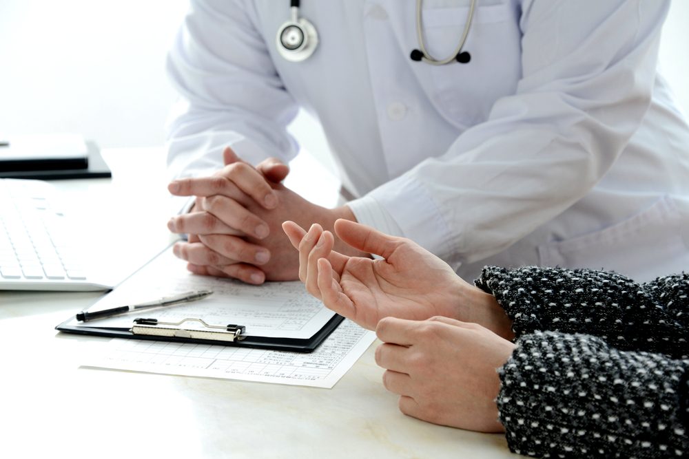 Patient's hand explaining for doctor