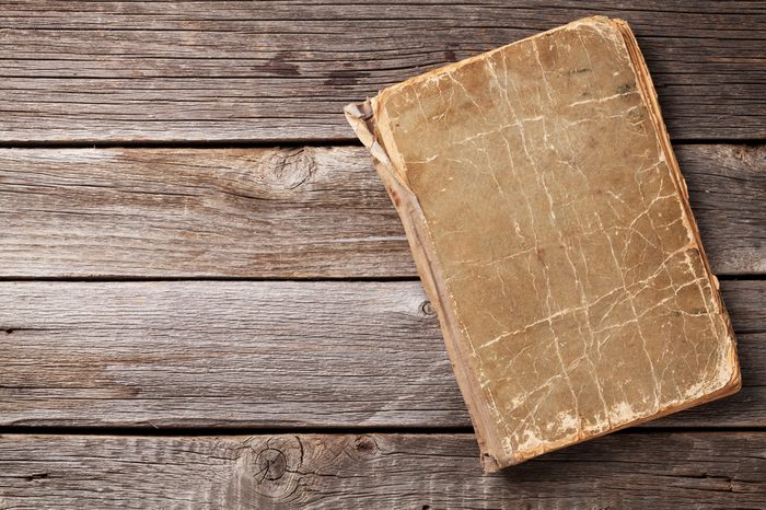 Vintage book on wooden background. Top view with copy space