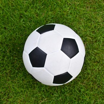 Soccer football on green grass field, Top view