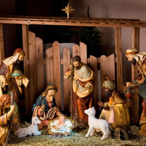 Christmas Manger scene with figurines including Jesus, Mary, Joseph, sheep and magi.