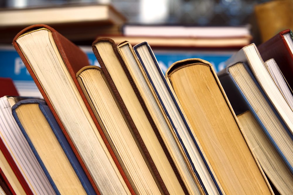 Old books leaning against each other for sale