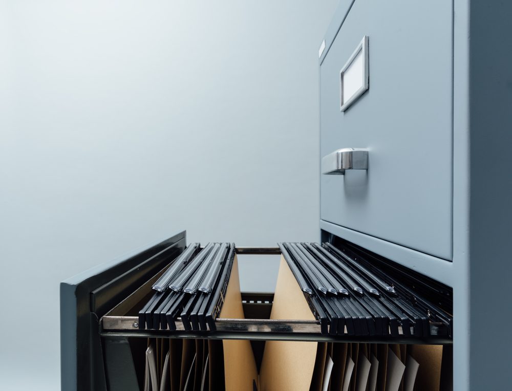 Filing cabinet with open drawer and files inside: data storage and archives