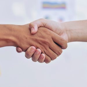 Business partnership meeting concept. Image businessman handshake. Successful businessmen handshaking after good deal. Horizontal, blurred background.Split tone instagram like process.