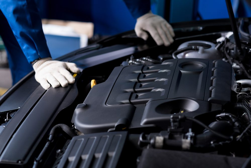 Professional mechanic checking car engine