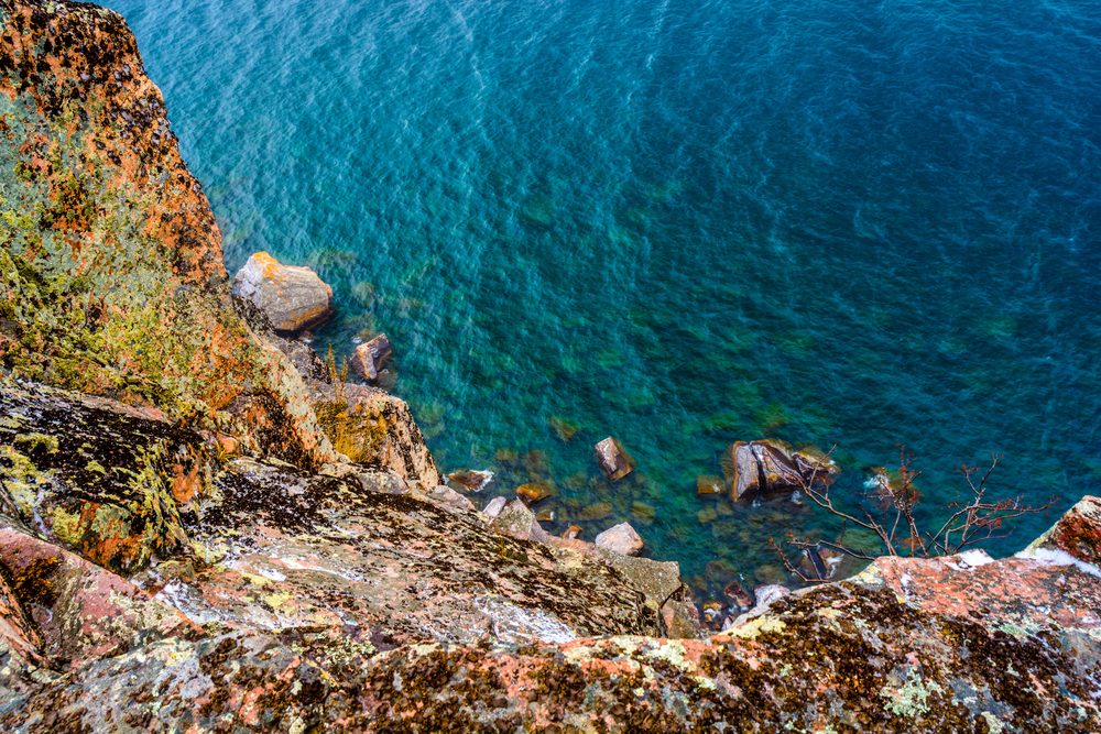 A view looking down the cliff into the beautiful waters of Lake Superior from the Palisade Head Cliffs on the North Shore in Minnesota.