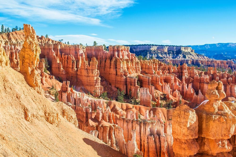 Red-yellow rocks in Bryce Canyon. Panorama of the mountain massif. A tourist place, a stone forest.