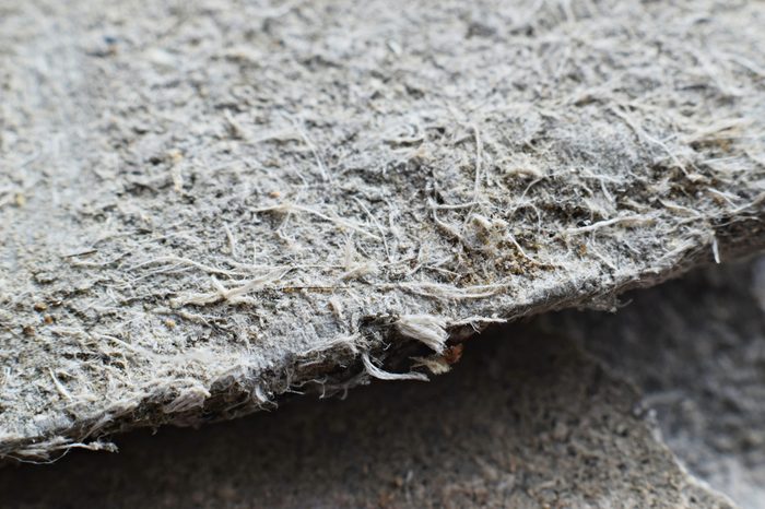 Detailed photography of roof covering material with asbestos fibres. Health harmful and hazards effects. Prolonged inhalation of microscopical fibers causes fatal illnesses including lung cancer. 