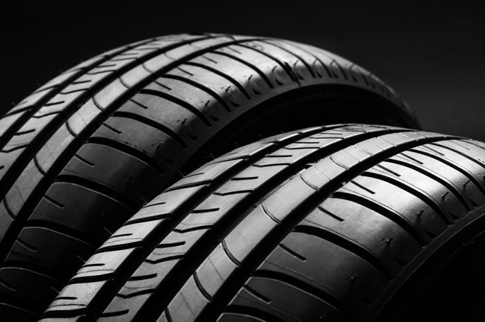 Studio shot of a set of summer, fuel efficient car tires on black background. Contrasty lighting and shallow depth of field